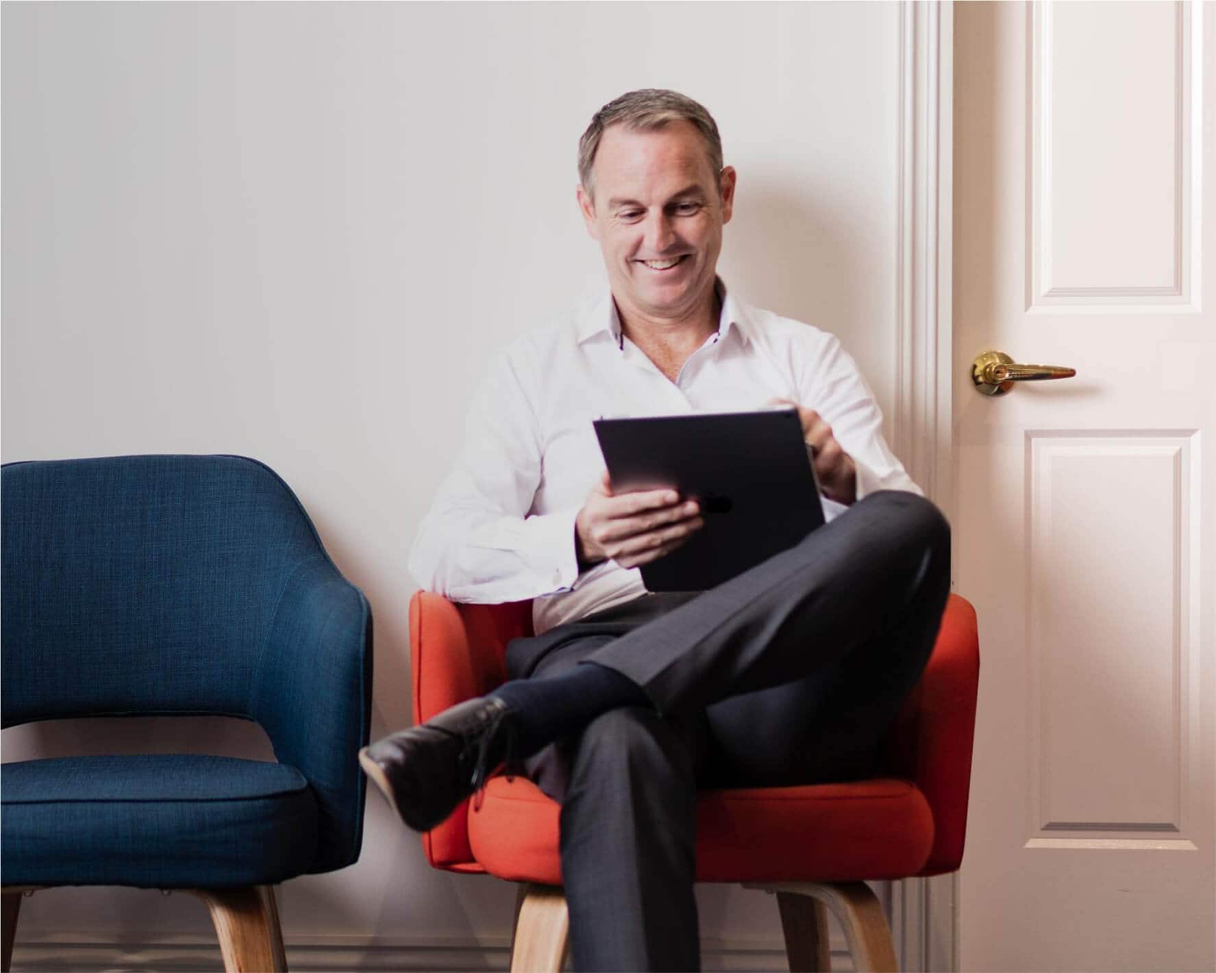A client uses Xero on their tablet while waiting in a medical practice waiting room.