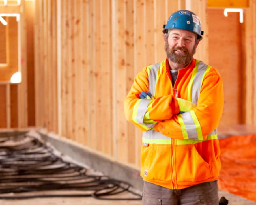 A construction worker, who uses accounting software, on a building site.