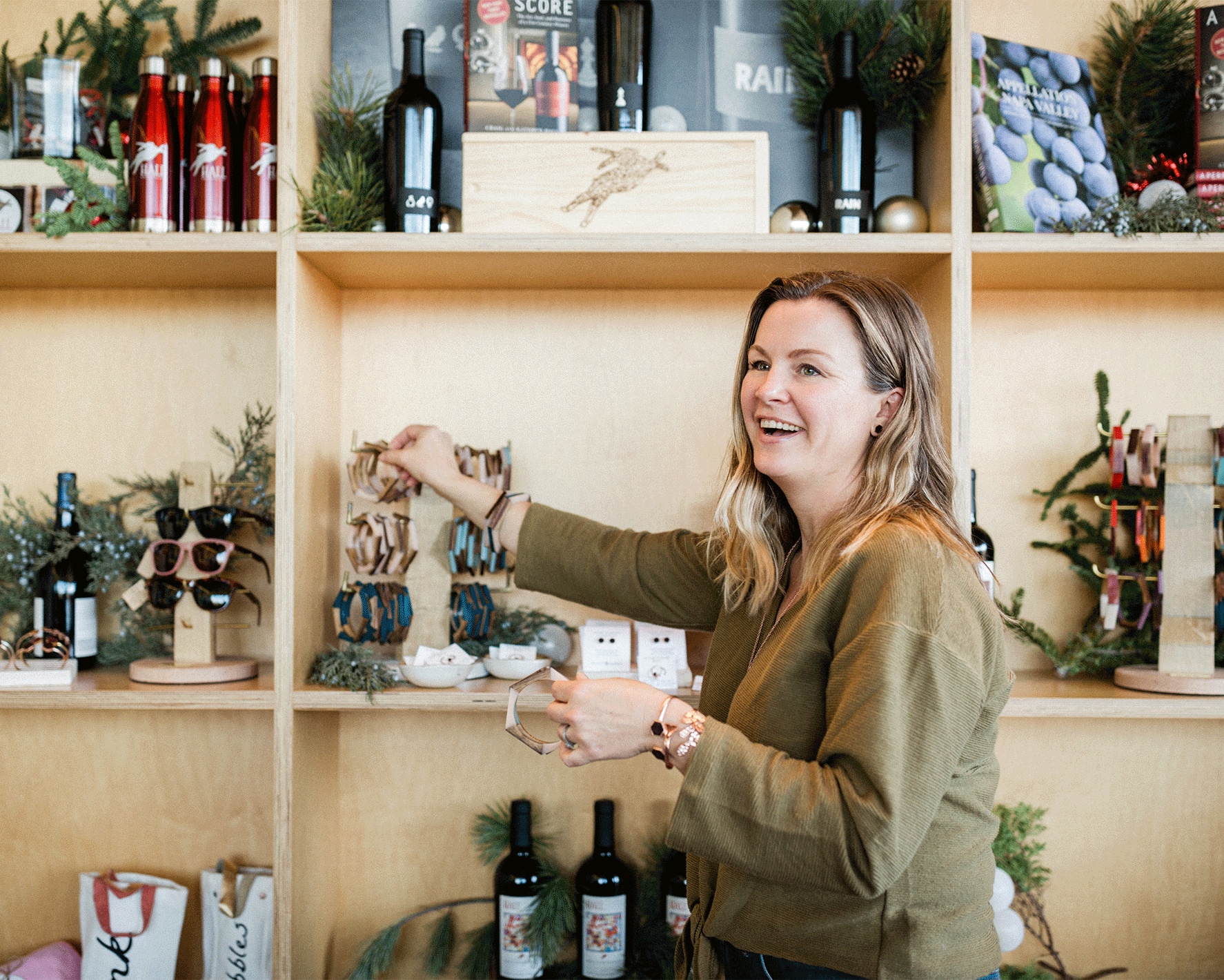 Woman in her retail store, Olive and Poppy. She uses Xero accounting software.