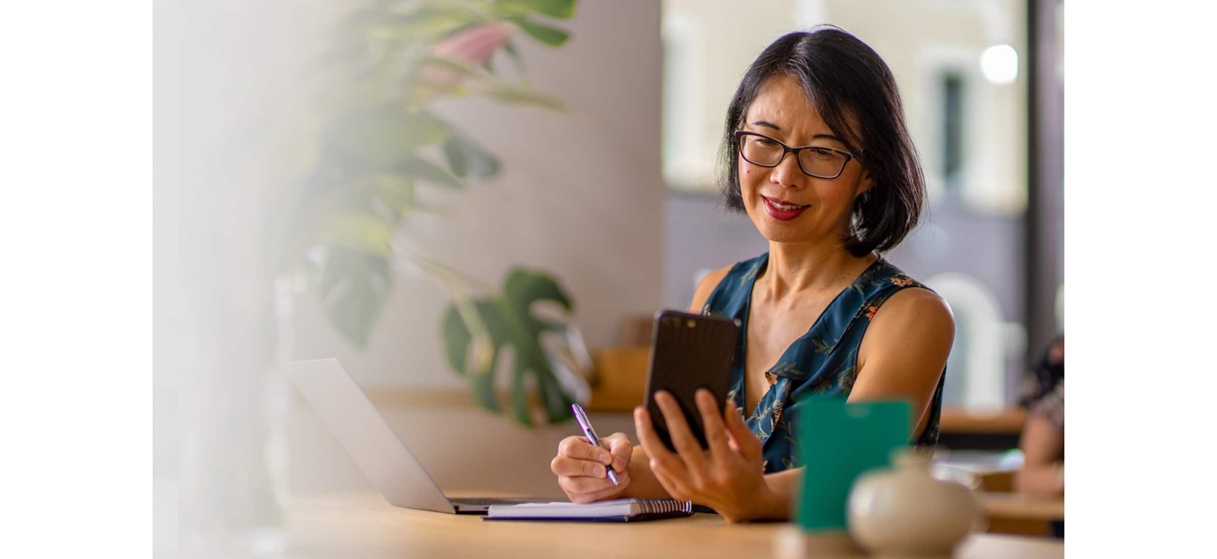 A small business owner uses their laptop and mobile phone to set up multi-factor authentication for their Xero account.