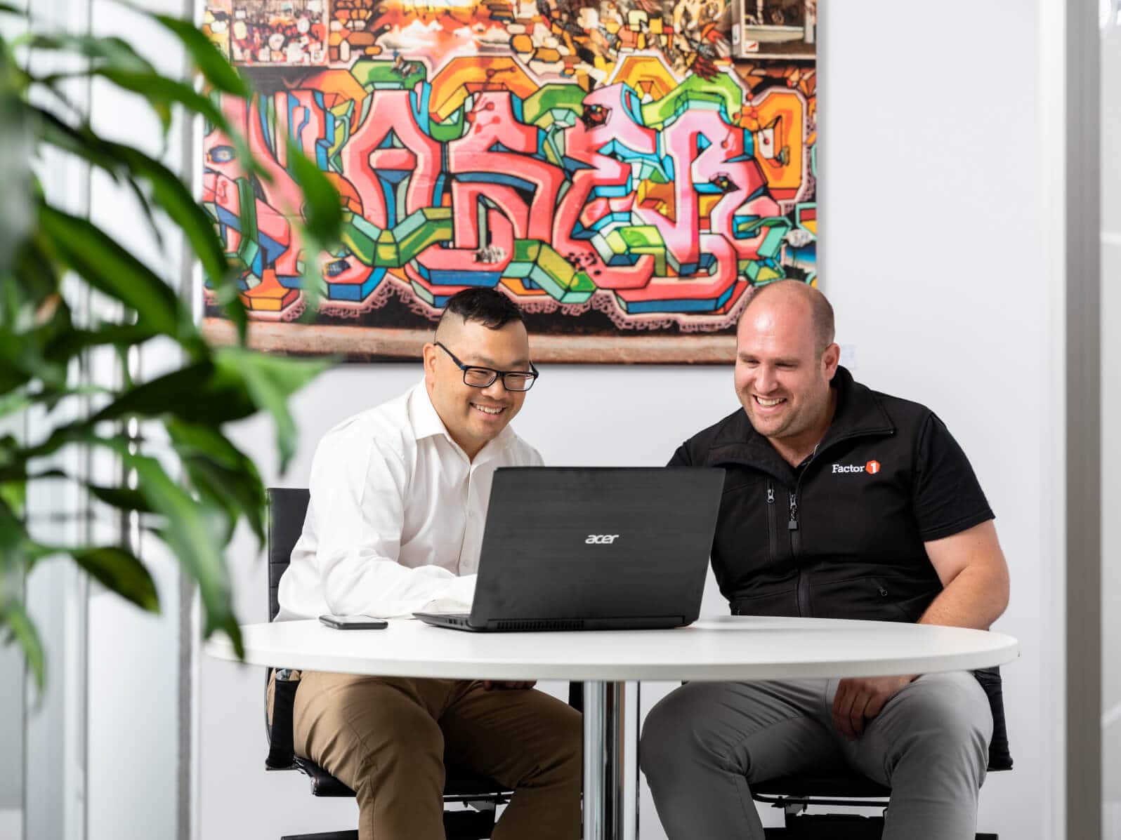 An accountant discusses an onscreen report with a client.