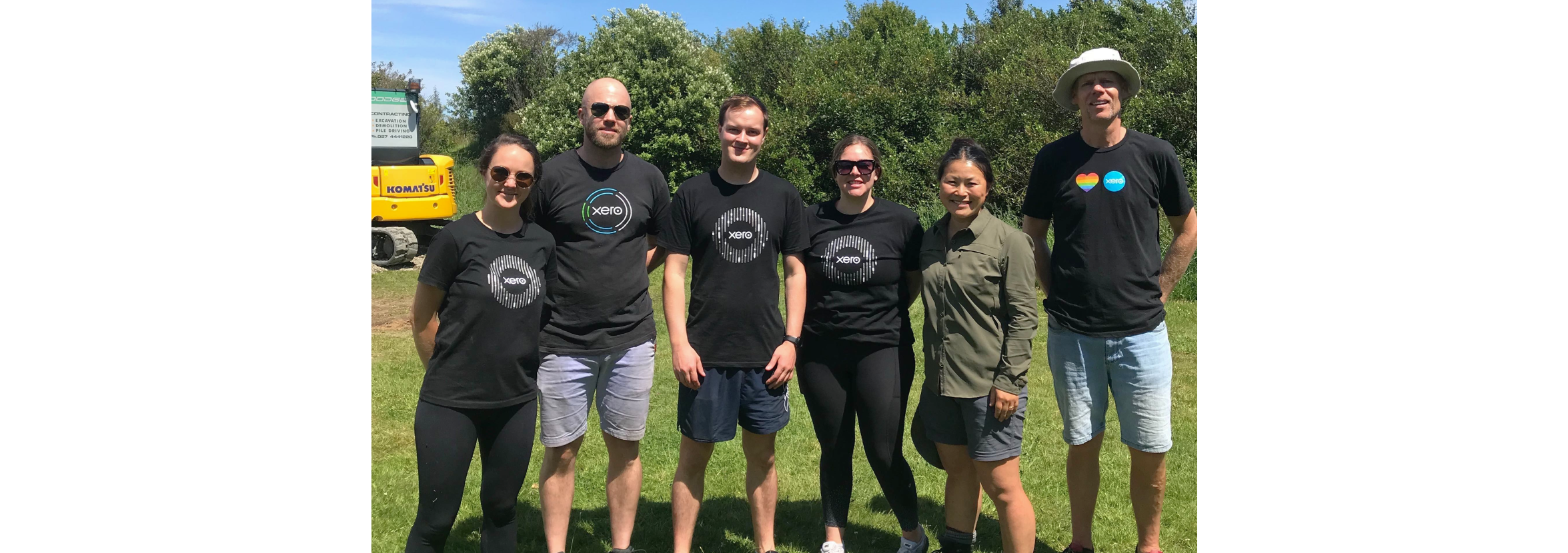 Xero staff members outside standing in a volunteer group.