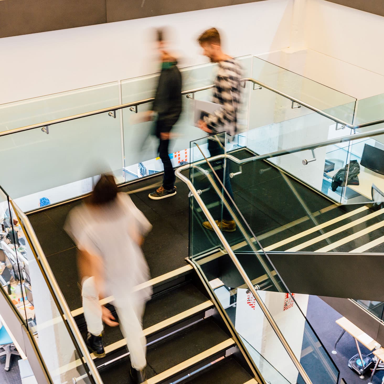 Xeros chat and greet each other as they climb a stairwell at one of our global offices.