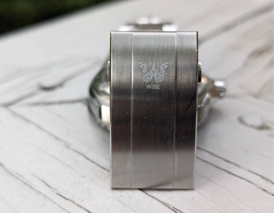 Engraved clasp of WISE ADX 110 True GMT stainless steel bracelet showing brand logo